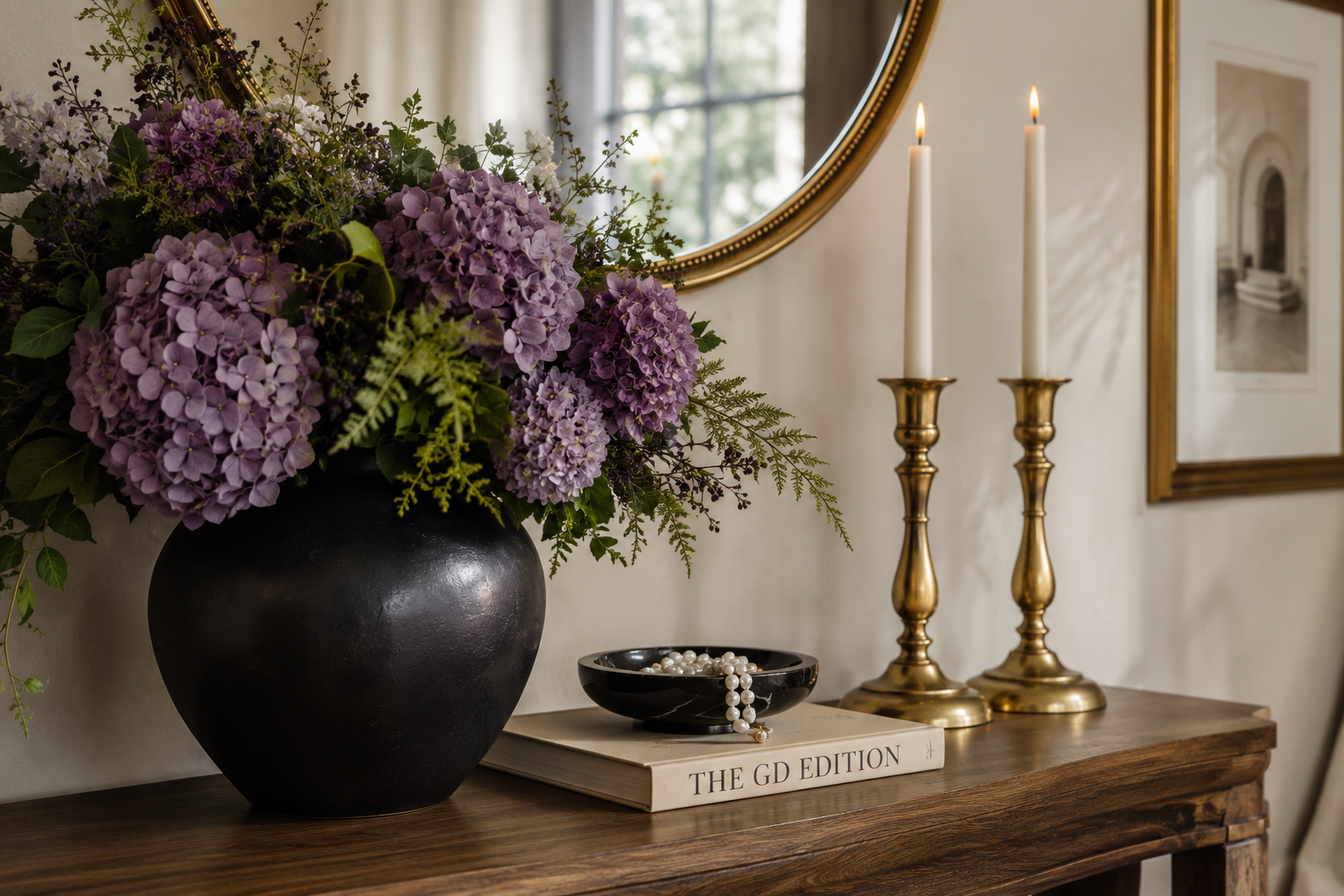 How to Style an Elegant Entryway Table Elegant wooden entryway console styled with a black vase, purple hydrangeas, brass candle holders, and neutral decor